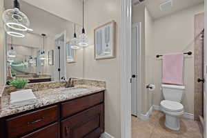 Bathroom featuring vanity, light tile patterned flooring, and walk in shower