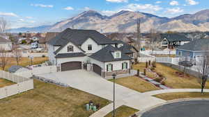 French provincial home with stucco siding, a residential view, concrete driveway, and stone siding