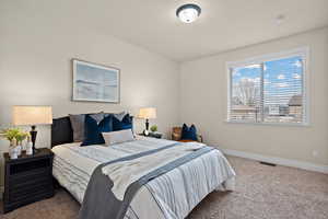 Bedroom featuring carpet floors and baseboards
