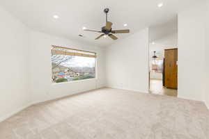 Empty room featuring light carpet, ceiling fan, lofted ceiling, and recessed lighting