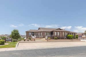 View of front of home with brick siding and a porch