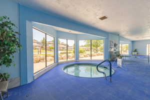 View of pool with a sunroom, a swimming pool, and a residential view