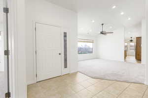 Foyer entrance featuring light carpet, recessed lighting, and light tile patterned floors