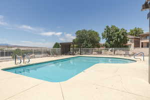 Community pool with a patio area and a pergola