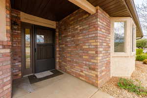Doorway to property with brick siding