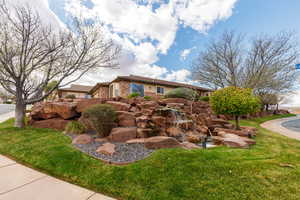 View of front of home with a front lawn and brick siding
