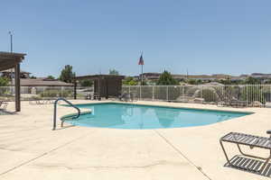 Community pool with a pergola and a patio area