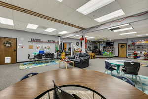 Dining room with a paneled ceiling and carpet floors