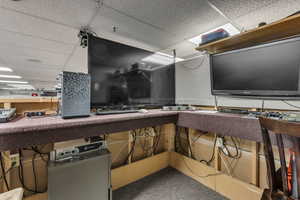 Detailed view of a paneled ceiling and carpet floors