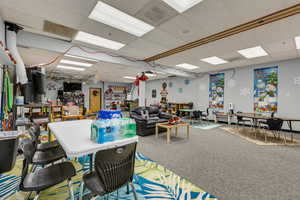 Dining room featuring carpet and a drop ceiling