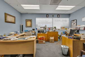 Office with a paneled ceiling