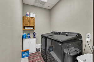 Laundry area with a drop ceiling, independent washer and dryer, and cabinet space