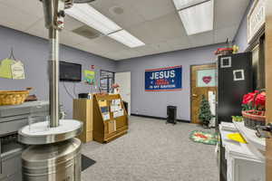 Game room featuring a paneled ceiling and radiator heating unit