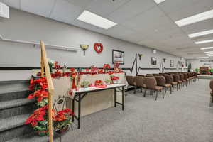 Misc room featuring a paneled ceiling and stairway