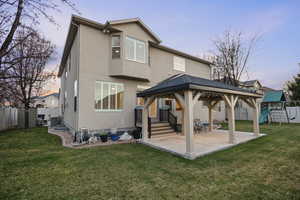 Rear view of property with patio, gazebo, storage shed, playground, and full fence.