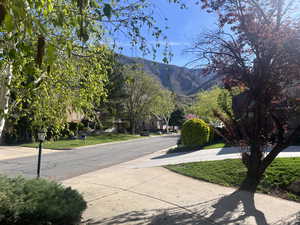View of asphalt road with a mountain view and sidewalks
