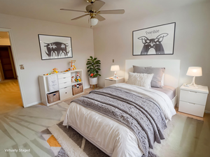 Bedroom with ceiling fan and light colored carpet