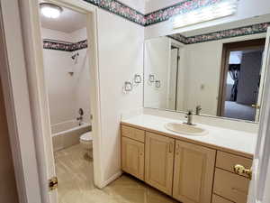 Bathroom with vanity, bathing tub / shower combination, and a textured ceiling