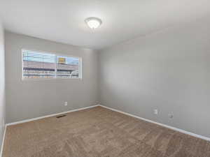Unfurnished room featuring carpet floors and baseboards