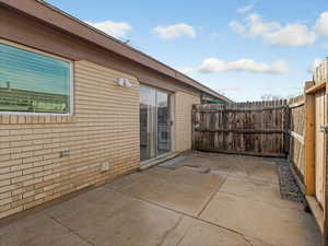 Fenced backyard with a patio area