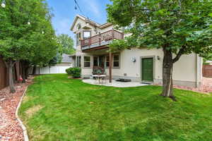 Rear view of property with a patio, a fenced backyard, and stucco siding