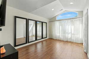 Spare room featuring dark wood-type flooring and recessed lighting
