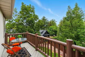 Wooden terrace featuring outdoor dining area