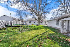 View of yard featuring a trampoline