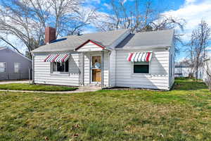 Bungalow-style house featuring a chimney