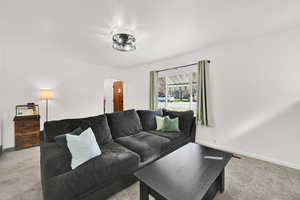 Living area with arched walkways and light colored carpet