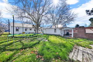 Back of house featuring a patio area and a yard