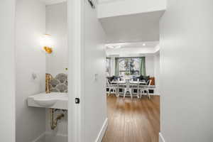 Main floor 1/2 bath with penny tile flooring and updated sink and lighting