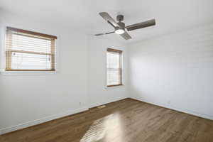 Bedroom  with wood-look flooring and a ceiling fan