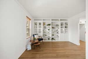 Perfect for a formal living room, music room or office. Featuring wood-look floors and built in cabinets