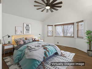 Primary suite with dual closets, wood look floors, ceiling fan and lots of windows for tons of natural light