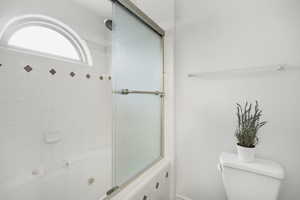 Primary bathroom featuring a oversized tub/shower combo