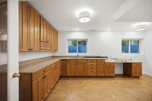 Craft or hobby room with built-in cabinets and counters. Could be converted to a kitchenette if desired