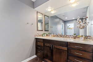 Bathroom featuring vanity and tasteful backsplash