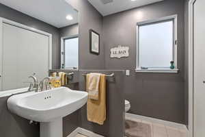 Bathroom with light tile patterned floors and recessed lighting