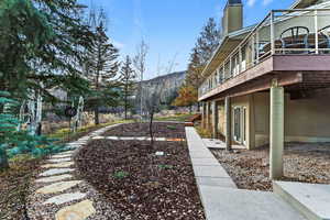 View of yard with a deck with mountain view