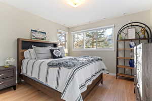 Bedroom with light wood-type flooring and baseboards