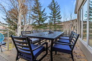 Wooden deck featuring outdoor dining area