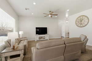 Living area featuring a ceiling fan and recessed lighting