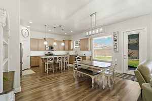 Dining room featuring dark wood finished floors and recessed lighting