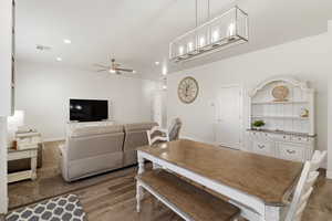 Dining room with light wood-style flooring, ceiling fan, and recessed lighting