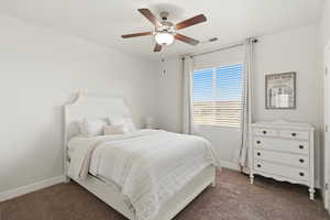 Bedroom featuring dark colored carpet and ceiling fan