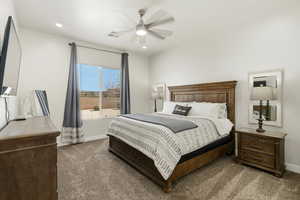 Bedroom featuring dark colored carpet, ceiling fan, and recessed lighting