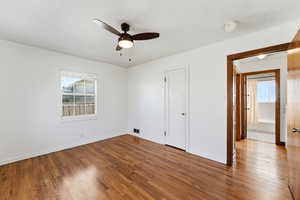 Unfurnished bedroom with dark wood finished floors and a ceiling fan