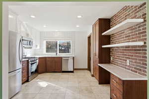 Kitchen featuring stainless steel appliances, open shelves, recessed lighting, backsplash, and light tile patterned flooring
