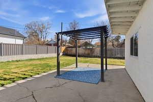 Fenced backyard with a patio area and a pergola